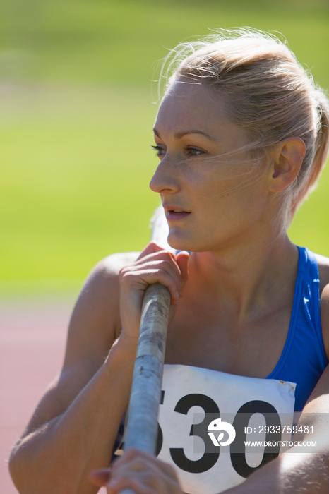 Female track and field athlete preparing to pole vault