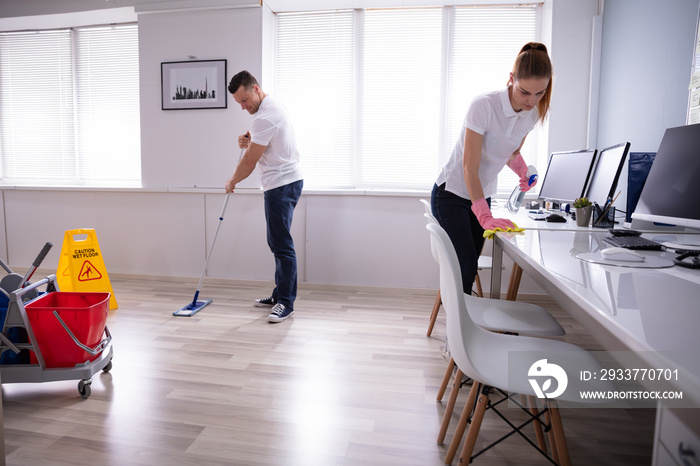 Smiling Two Young Janitor Cleaning The Office