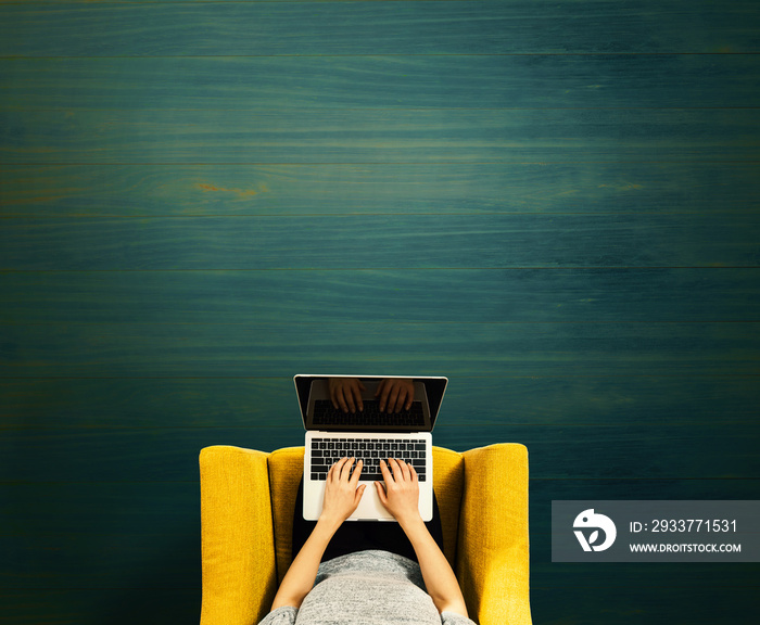 Woman using a laptop computer overhead view