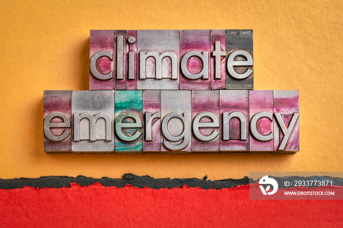 climate emergency word abstract in gritty vintage letterpress metal types against handmade paper, gl