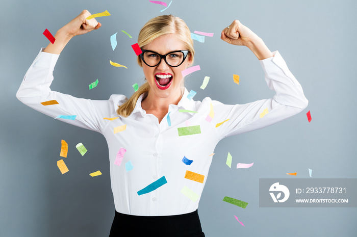 Young strong business woman celebrating with confetti