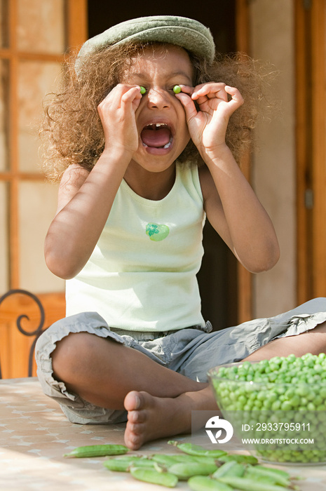 Girl shelling fresh peas