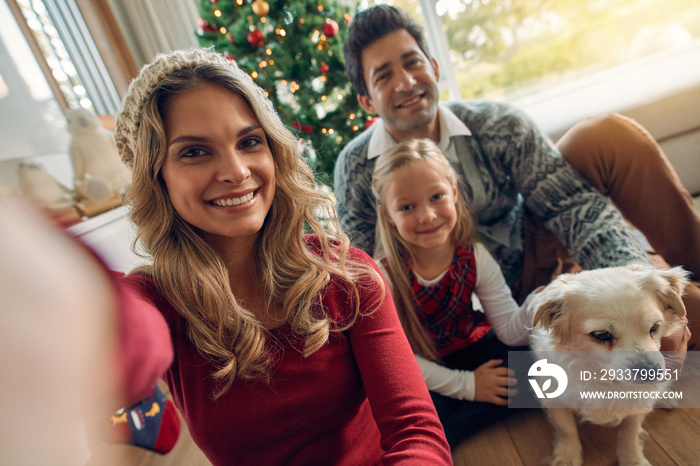 Caucasian family taking photos at Christmas