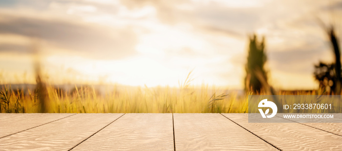 wooden table with blurred background of field of wheat. product display