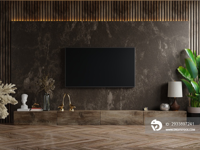 Mockup a TV wall mounted in a dark room with plant on dark marble wall background.