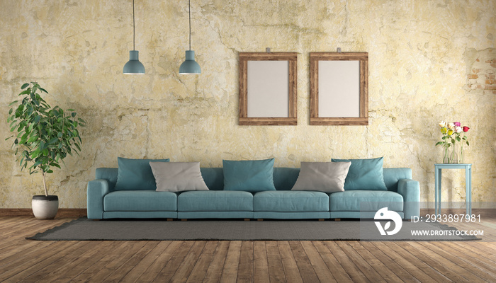 Modern blue sofa in a grunge room