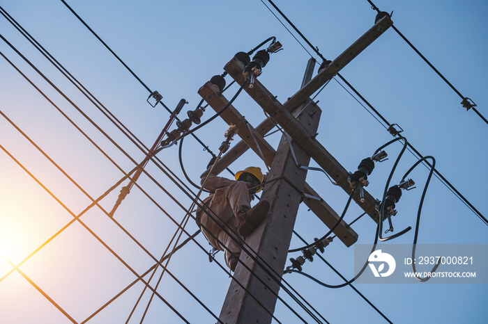 The power lineman uses insutated tool to open the connection of the transformer from the high voltag