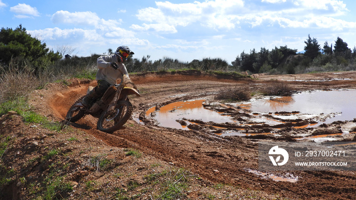 Zoom photo of unidentified motocross rider performing extreme stunts in off road dirt track