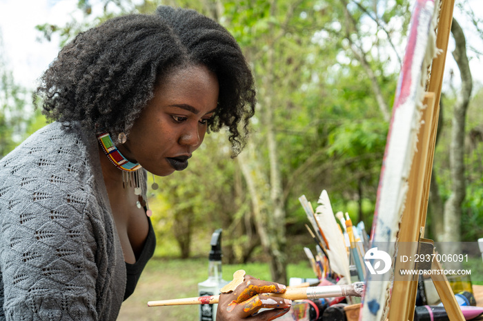 woman focused on her painting in the garden