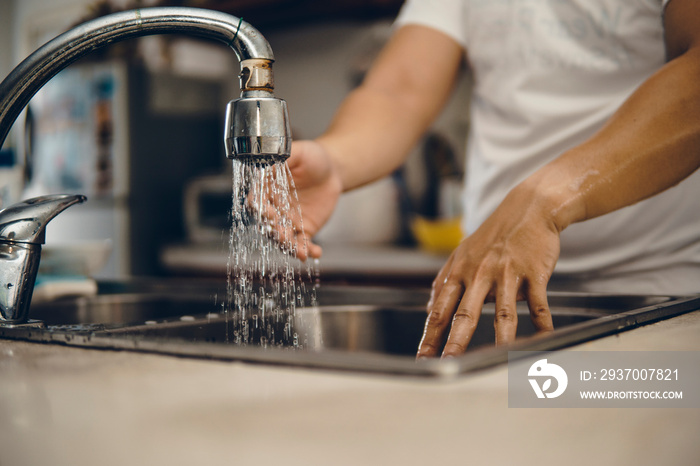 Cropped shot of an unrecognizable man washing his hands at home to prevent spreading of the coronavi