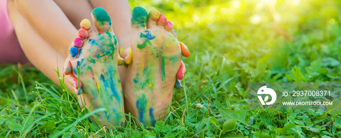 child with painted hands and legs. Selective focus.