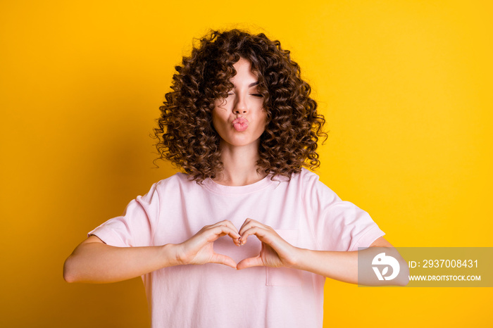 Photo portrait of romantic girlfriend with curly hairstyle showing heart sending air kiss isolated o