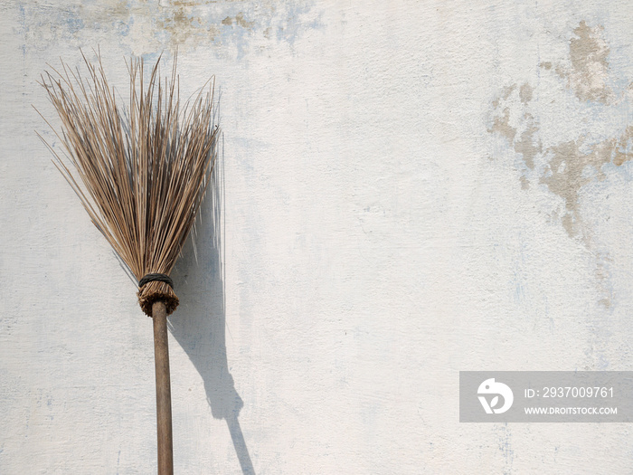 Old broom Laid against the wall