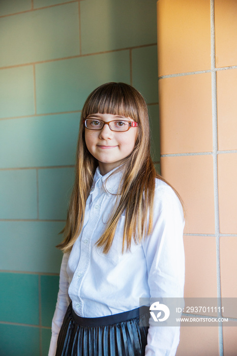 Portrait of student standing in school corridor