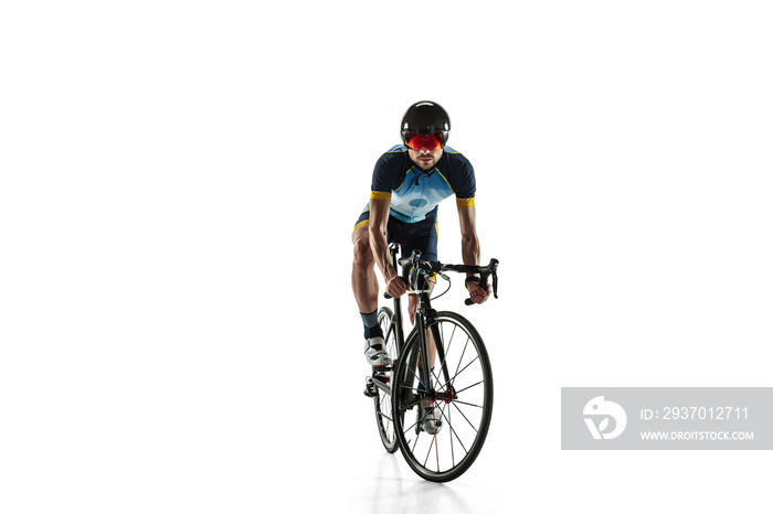 Triathlon male athlete cycle training isolated on white studio background. Caucasian fit triathlete 