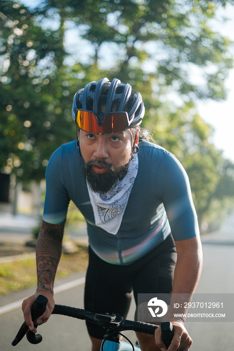 A bearded cyclist riding his gravel bike.