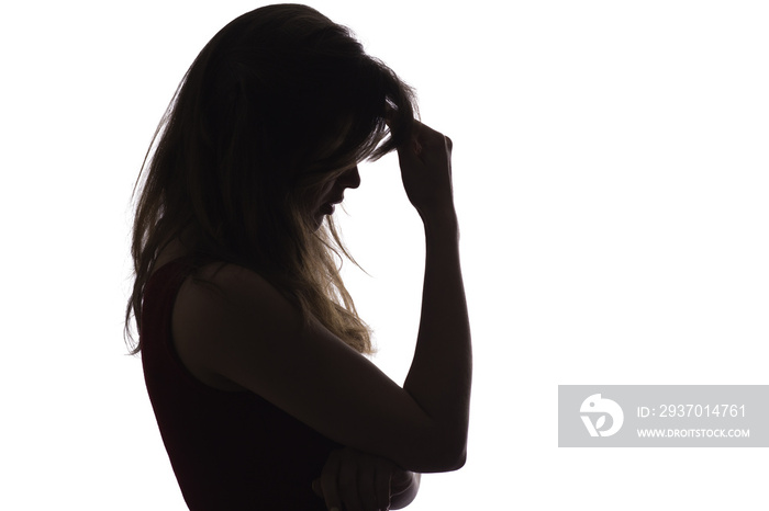 profile silhouette of a young upset woman, the girl leans her hand on her forehead and thinks about 