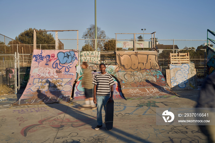 Three young skateboarders in skatepark skateboarding