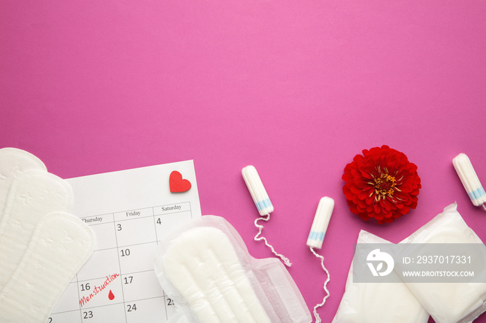 Menstruation calendar with cotton tampons and pads with flower on pink background. Woman critical da