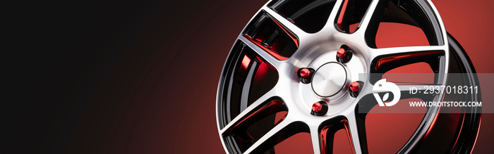 The new automotive alloy wheel is light and sporty red with shiny spokes on a red-black gradient bac
