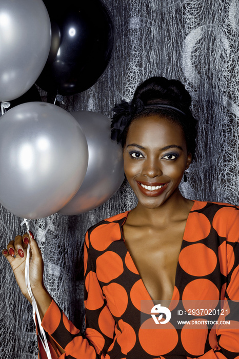 Portrait of young woman with balloons