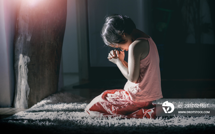 Little girl praying in home, Prayer concept for faith,spirituality and religion.