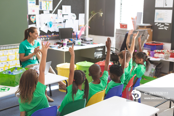 Teacher discussing about green energy and recycle at desk in classroom