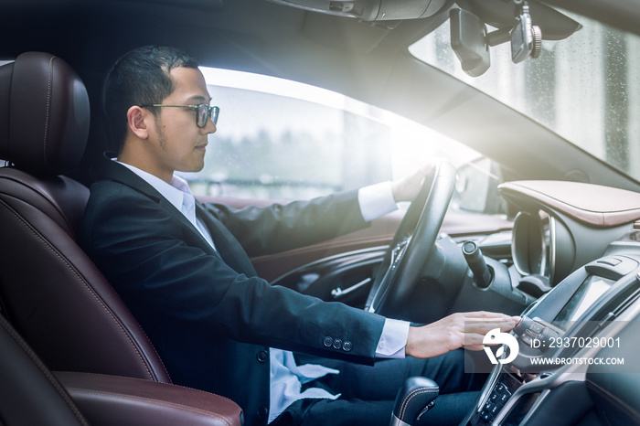 detail shot of young businessman driving his car.