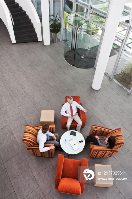 Overhead view of business meeting in office atrium