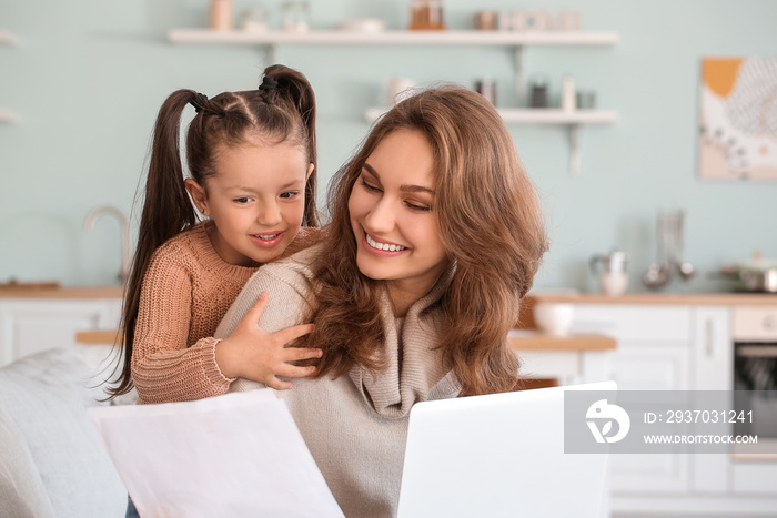 Working mother with little daughter at home