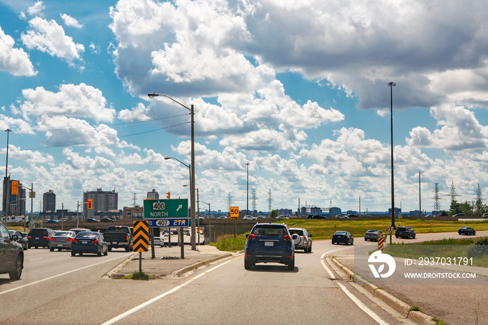 Beautiful landscape midday view of Toronto city highway street with cars traffic during sunny day wi