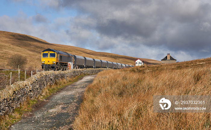 A train sat at the isolated train station of Blea Moor in the Yorkshire Dales.