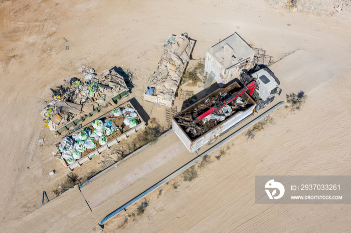 Loaded Truck approaching a weigh station with a full load of scrap metals, Aerial view.