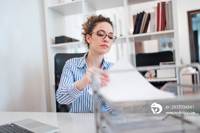 Young female administrative assistant at work.