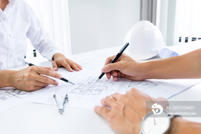 Close up of engineer hands discussing a building construction project at workplace