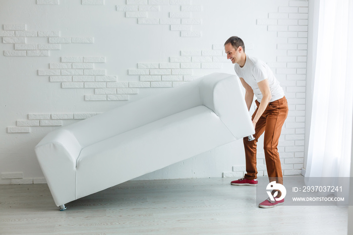 new home, real estate, moving and furniture concept - close up of male lifting up sofa or couch