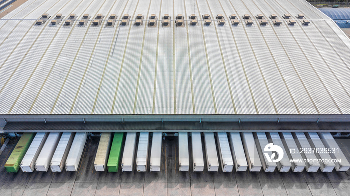 Aerial top view of truck and cargo trailer unloading in logostics center.