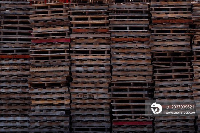 Pile of old wooden pallet. Industrial wood pallet stacked at factory warehouse. Cargo and shipping c