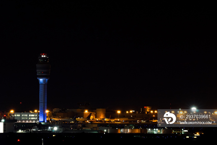 nightime view of the Atlanta international airport with air traffic control and streaks of planes ta