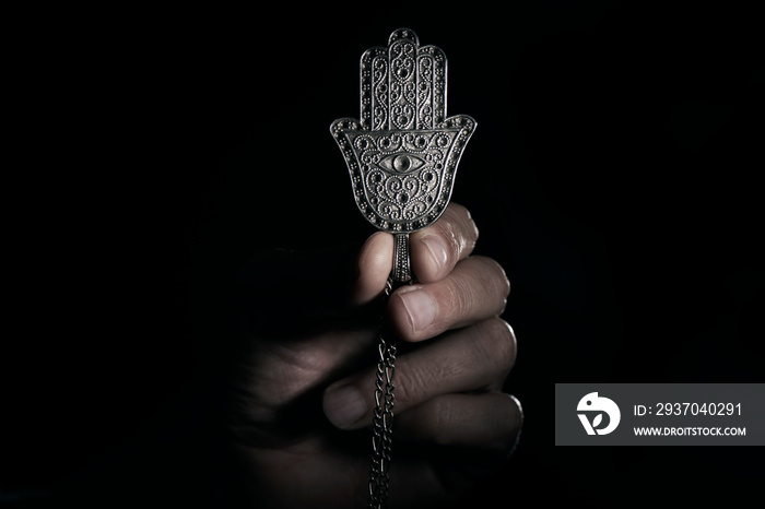 man with an old hamsa amulet or hand of fatima