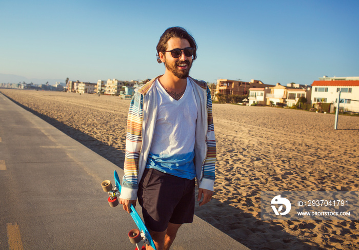 Portrait of man holding longboard