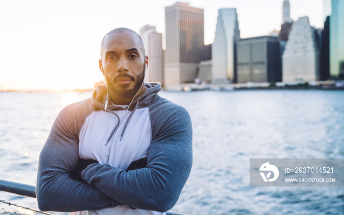 Serious sporty black man with arms crossed looking at camera