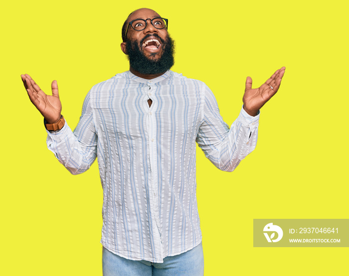 Young african american man wearing business shirt and glasses celebrating mad and crazy for success 