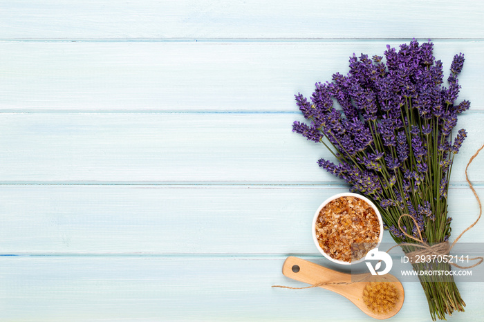 Grooming products and fresh lavender bouquet on white wooden table background.