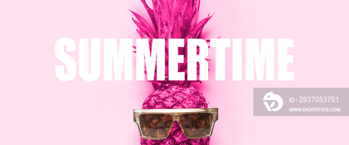 pink whole pineapple in sunglasses on a pink background. Added the word Summertime. Top view, flat l