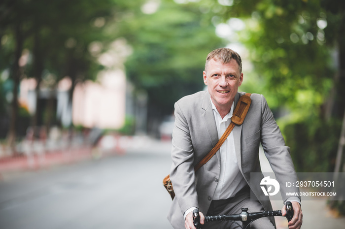 professional adult caucasian businessman person ride a bicycle to work, bike using lifestyle outside