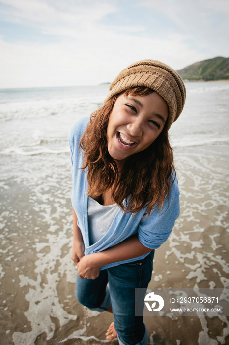 Smiling woman playing in waves