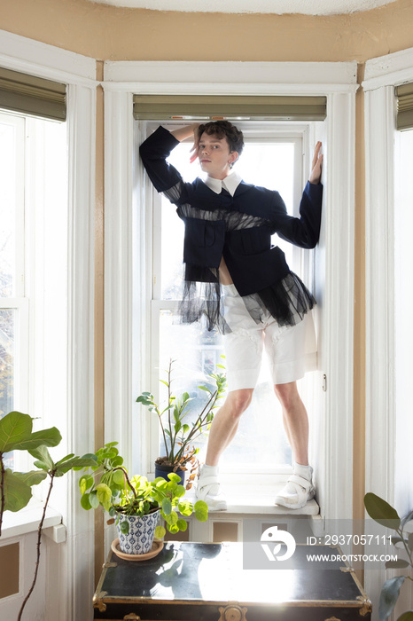 portrait of non-binary caucasian person with short brown hair at home