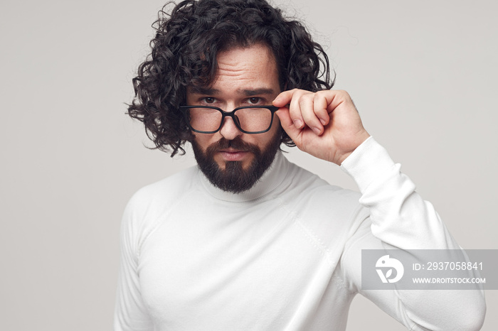 Handsome man in glasses looking at camera