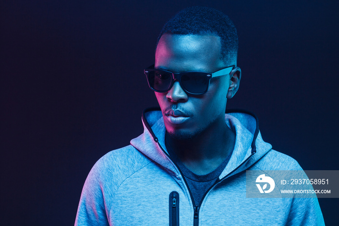 Close-up portrait of handsome black man, wearing hoodie and sunglasses